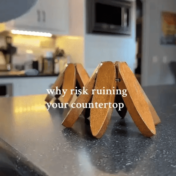 Wooden Christmas tree trivet protecting a kitchen surface