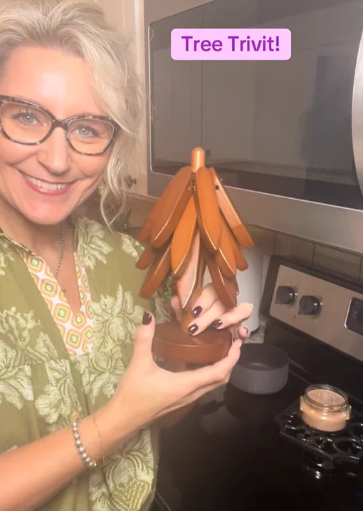 Customer holding wooden Christmas tree trivet